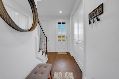 A bright, welcoming entryway with hardwood floors,