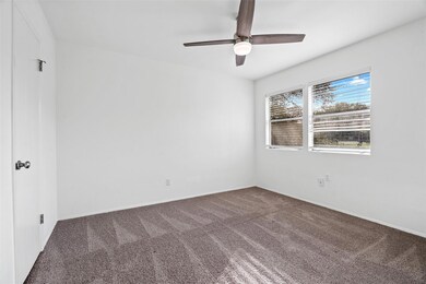 Carpeted empty room featuring baseboards and a ce