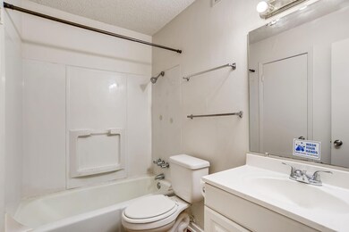 Bathroom featuring a textured ceiling, vanity, an