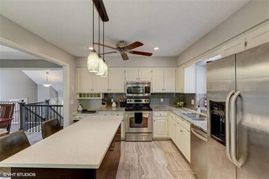 White kitchen with Quartz countertops and stainles