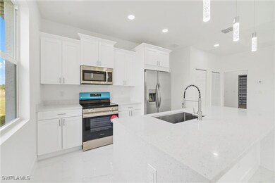Kitchen with visible vents, white cabinets, stainl