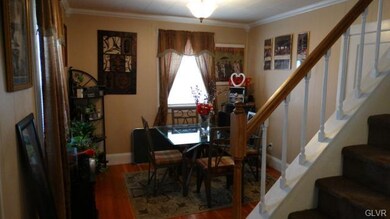 Dining Room with Crown Molding and Deep Baseboard 