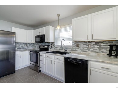 Beautifully updated kitchen with glass backsplash
