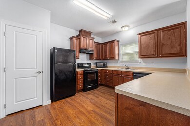 This kitchen features warm wood cabinets, laminate