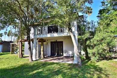 Back of house featuring french doors, a patio area, and a lawn