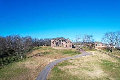 This 5 bedroom 4.5 bath all brick home is stunning inside and out with a beautiful stately drive to the home and unobstructed amazing views of the hillside. 