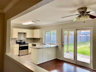 Kitchen featuring white cabinets, tasteful backspl