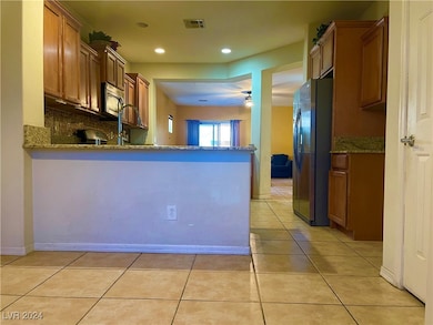 Kitchen with stainless steel appliances, visible v