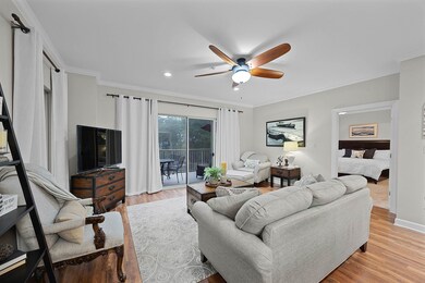Living area featuring a ceiling fan, light wood-style flooring, recessed lighting, and crown molding
