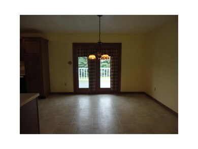 Kitchen. French doors lead out to the deck and fen