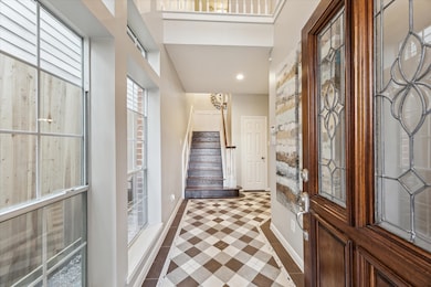 Bright entryway with large windows, a decorative w