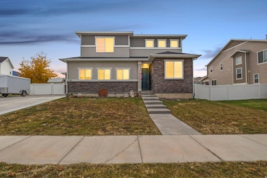 View of front of home featuring stucco siding and stone siding