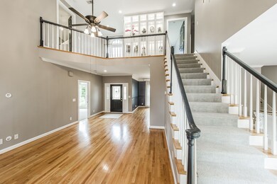 Open living areas start in the Entry Foyer with rich Sand & Finish Hardwood floors.
