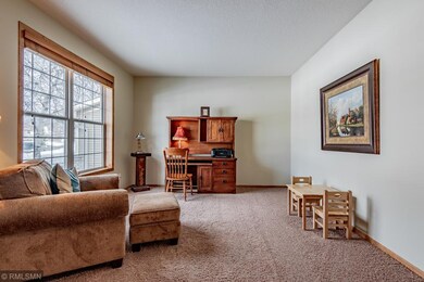 Large office with a window and front yard views.