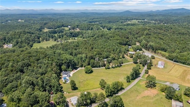 Aerial overview of property's location with a forest and a mountain backdrop