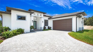 View of front of house with stucco siding, an atta