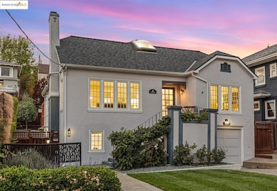 View of front of house featuring a chimney, an attached garage, stucco siding, and a shingled roof