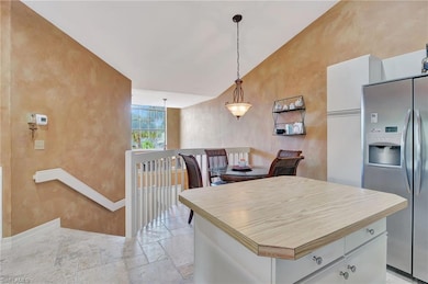 Kitchen featuring stainless steel fridge, baseboar