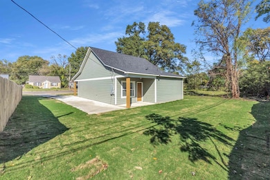Back of property with a patio and a shingled roof