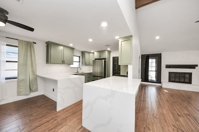 Modern style renovated kitchen with waterfall quartz countertops and custom built cabinetry