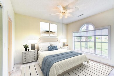 Bedroom featuring baseboards, ceiling fan, a textu
