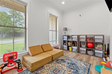Playroom featuring wood finished floors and crown 