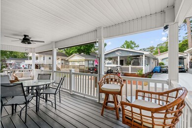 Wooden terrace with covered porch, a ceiling fan, 