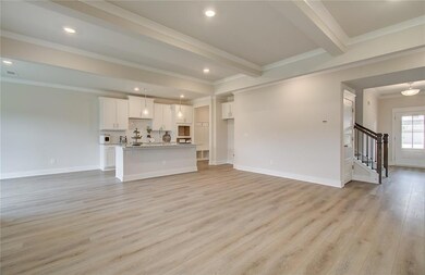 Unfurnished living room featuring light wood-style flooring, ornamental molding, stairway, baseboards, and recessed lighting