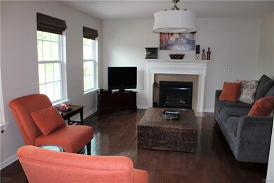 Family room with gas fireplace and beautiful hardw