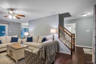 Living room featuring ceiling fan, hardwood / wood