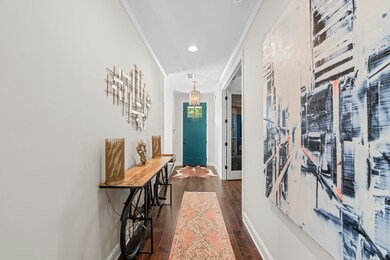 Foyer entrance with dark wood finished floors, baseboards, ornamental molding, and recessed lighting