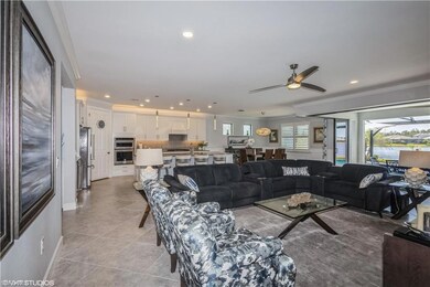 Living room featuring ornamental molding, light ti