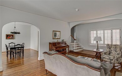 Upon entering the home, the living room is ahead, and dining room is to the left. Living room features hardwood floors, arched doorways and large windows with plantation shutters.
