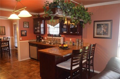 Kitchen with breakfast bar and stainless steel appliances.