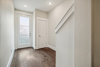 Inviting front entry with wood flooring, hall stor