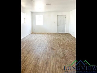Empty room with visible vents, baseboards, and wood finished floors