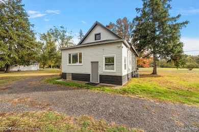 View of property exterior featuring a yard