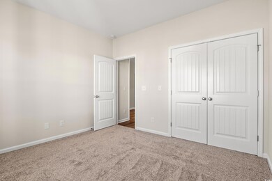 Unfurnished bedroom featuring a closet and carpet 