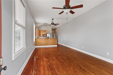 Living Room open to kitchen with tall vaultd ceili