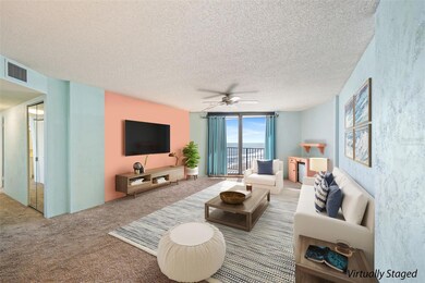 Virtually staged to showcase the potential of this bright and airy living space. Expansive ocean views pour in through the floor-to-ceiling sliding door, filling the room with natural light and a serene coastal ambiance