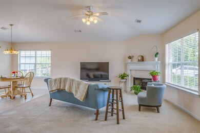 The Den features a gas log fireplace, ceiling fan,