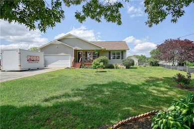 Ranch-style house featuring a porch, an attached g
