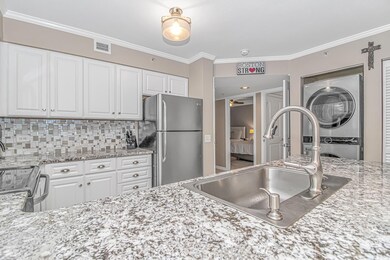 Kitchen featuring ornamental molding, appliances w