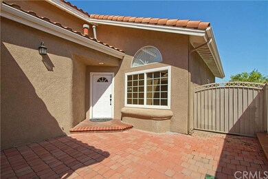 View of the front entrance with spacious patio are