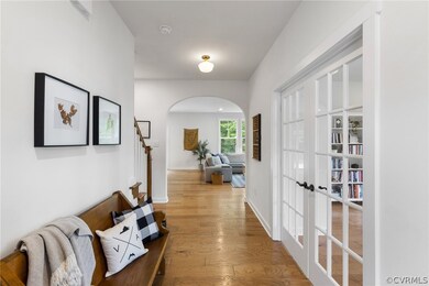 Hall with french doors and hardwood / wood-style f