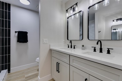 Full bathroom featuring wood finished floors, doub