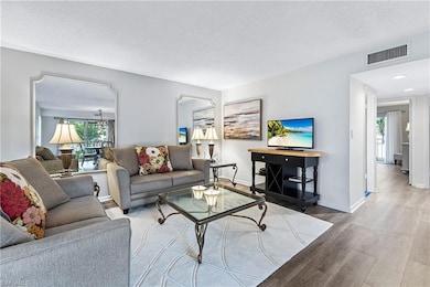 Living area with wood finished floors and a textured ceiling