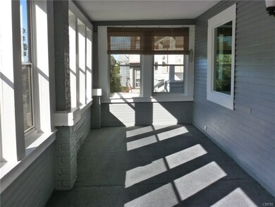 Enclosed front porch with new windows and carpetin