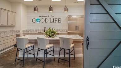 Kitchen featuring a breakfast bar, sink, light sto