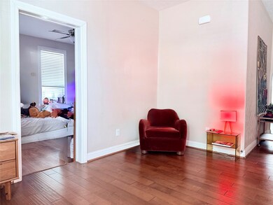 This inviting sitting area creates a warm transition from the entry to the bedroom — ideal for a small lounge or office setup.